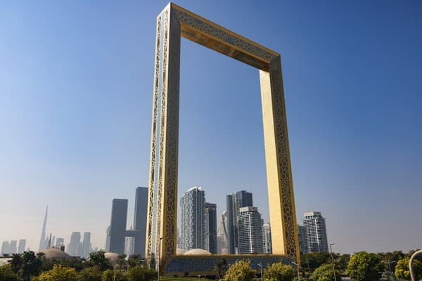 The iconic Dubai Frame stands tall with a modern cityscape backdrop, showcasing architectural brilliance.