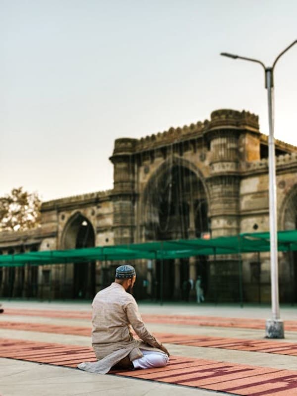 A man sits in prayer outside the historic Jama Masjid mosque in Ahmedabad, India.