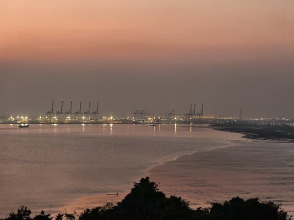 Vibrant twilight view of Hai Phong Port, Vietnam, illuminating the serene coastal landscape. Vibrant twilight view of Hai Phong Port, Vietnam, illuminating the serene coastal landscape.
