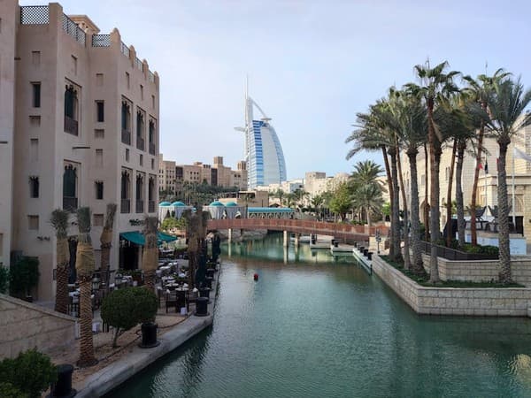 Scenic view of Burj Al Arab from Madinat Jumeirah canal, showcasing Dubai's modern architecture. Scenic view of Burj Al Arab from Madinat Jumeirah canal, showcasing Dubai's modern architecture.