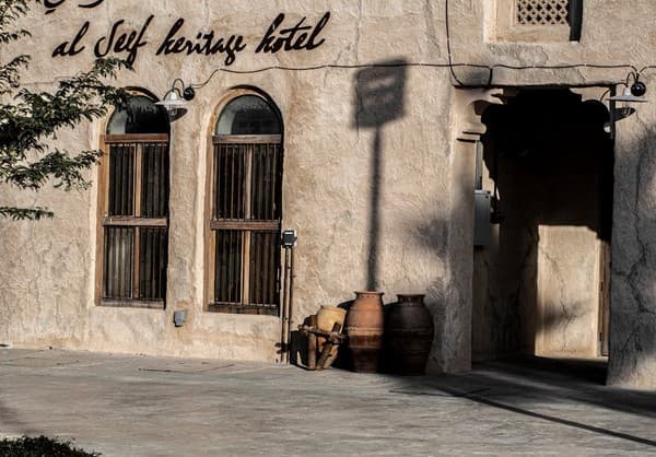 Facade of Al Seef Heritage Hotel showcasing traditional architecture in Dubai. Facade of Al Seef Heritage Hotel showcasing traditional architecture in Dubai.