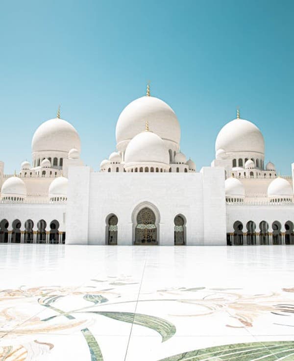 Stunning view of Sheikh Zayed Grand Mosque with its iconic domes and marble flooring. Stunning view of Sheikh Zayed Grand Mosque with its iconic domes and marble flooring.