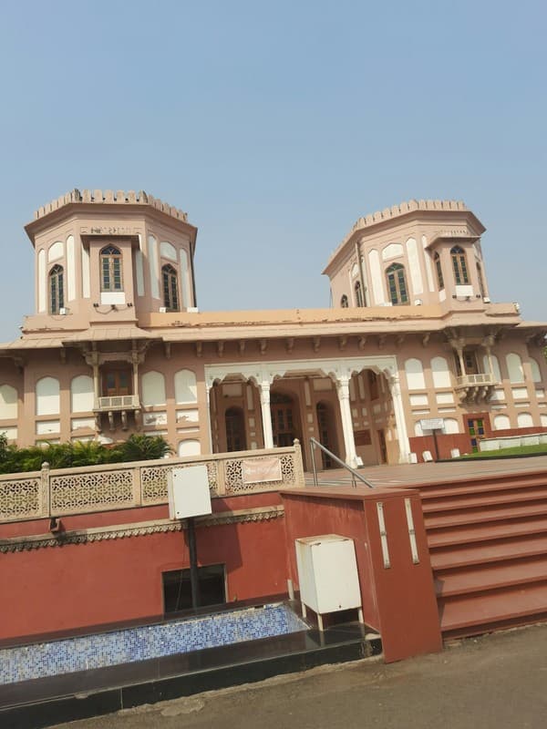 a large building with two towers on top of it a large building with two towers on top of it