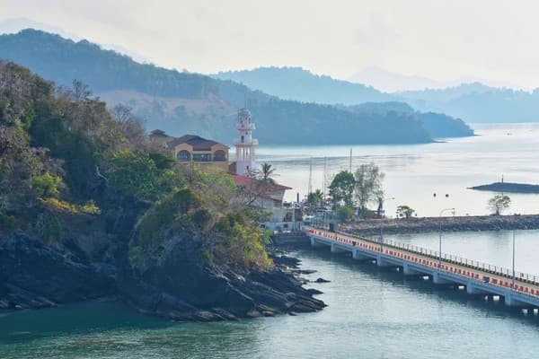 Serene view of Langkawi's coastline featuring a lighthouse and scenic landscape. Serene view of Langkawi's coastline featuring a lighthouse and scenic landscape.