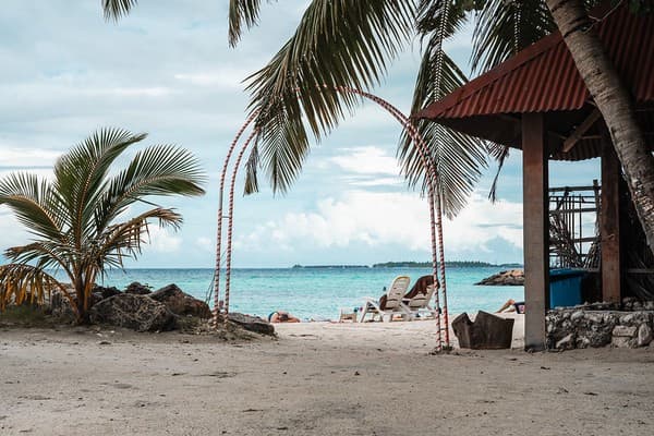 Maafushi Island, Maldives - November 26, 2019: Gateway entrance to Bikini Beach, a tourist beach where short swimwear and swimsuits are allowed in the Muslim country Maafushi Island, Maldives - November 26, 2019: Gateway entrance to Bikini Beach, a tourist beach where short swimwear and swimsuits are allowed in the Muslim country