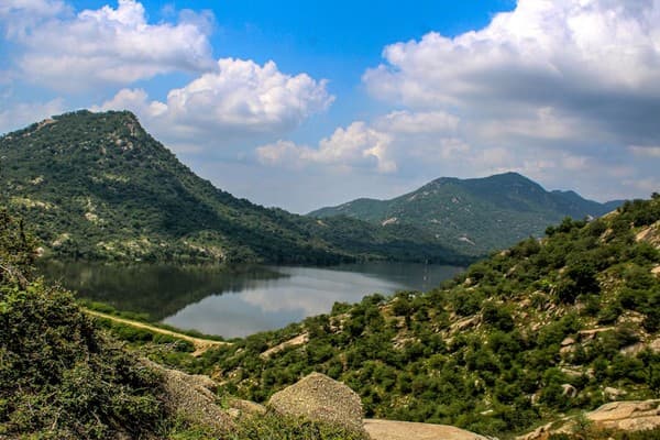 Beautiful mountain landscape with a serene lake reflecting the blue sky and clouds, capturing the essence of nature. Beautiful mountain landscape with a serene lake reflecting the blue sky and clouds, capturing the essence of nature.